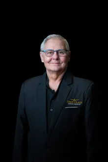 First Class Airport Transport chauffeur wearing glasses, in the company black blazer
