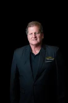 First Class Airport Transport chauffeur in the company black blazer, studio portrait